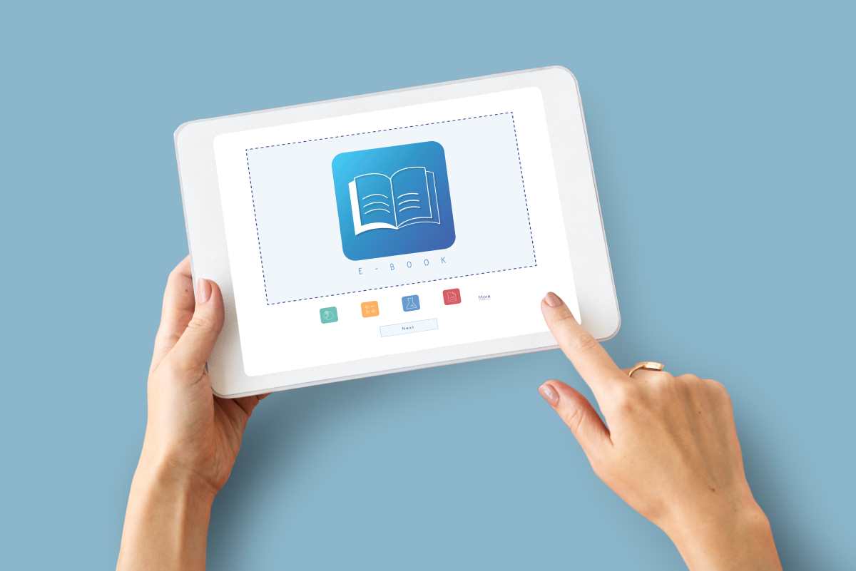 person using a tablet to read e-book or take online elearning course